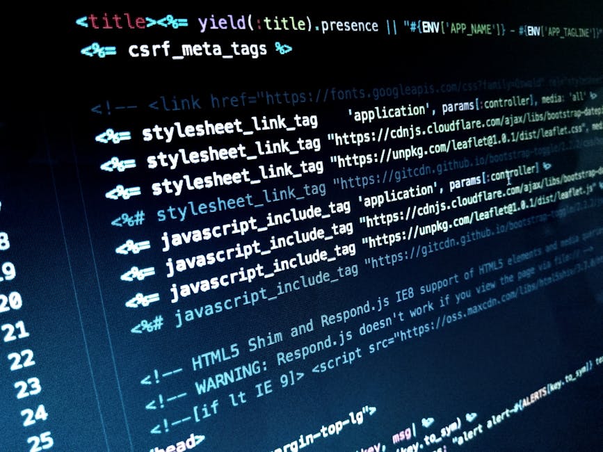 The image shows a close-up view of a workspace with a silver laptop open on the right side, displaying lines of code in a text editor with highlighted syntax. In the foreground, there are two spiral-b